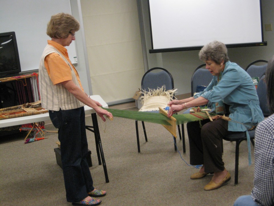 Laurel demonstrates backstrap weaving
