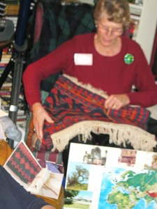 Anne mended her well-traveled rug.